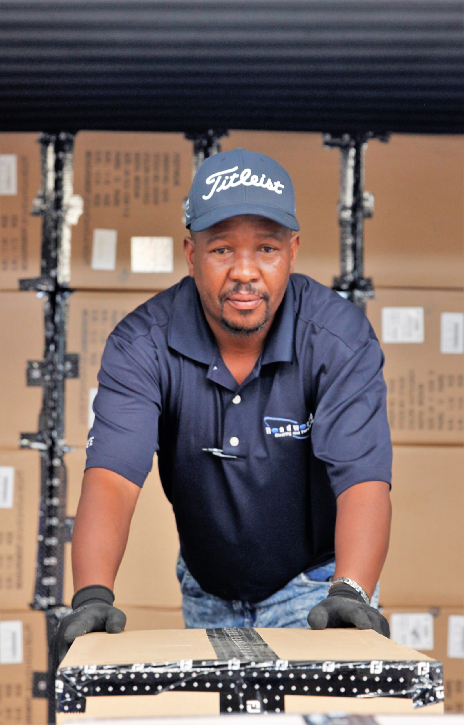 RWCF team member handling client cargo in the warehouse